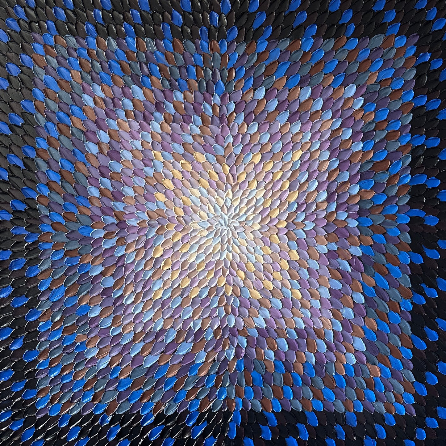 Mosaic pattern of blue and purple tiles arranged in a circular design.