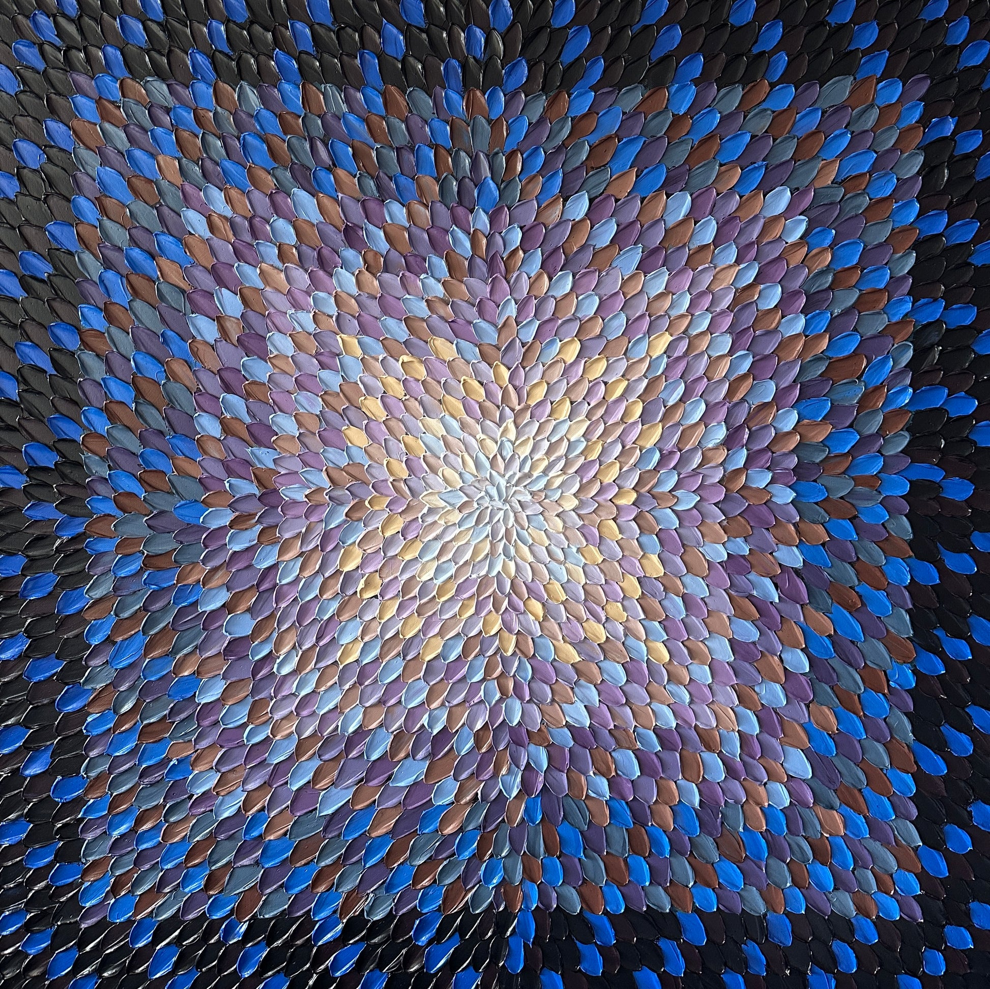 Mosaic pattern of blue and purple tiles arranged in a circular design.