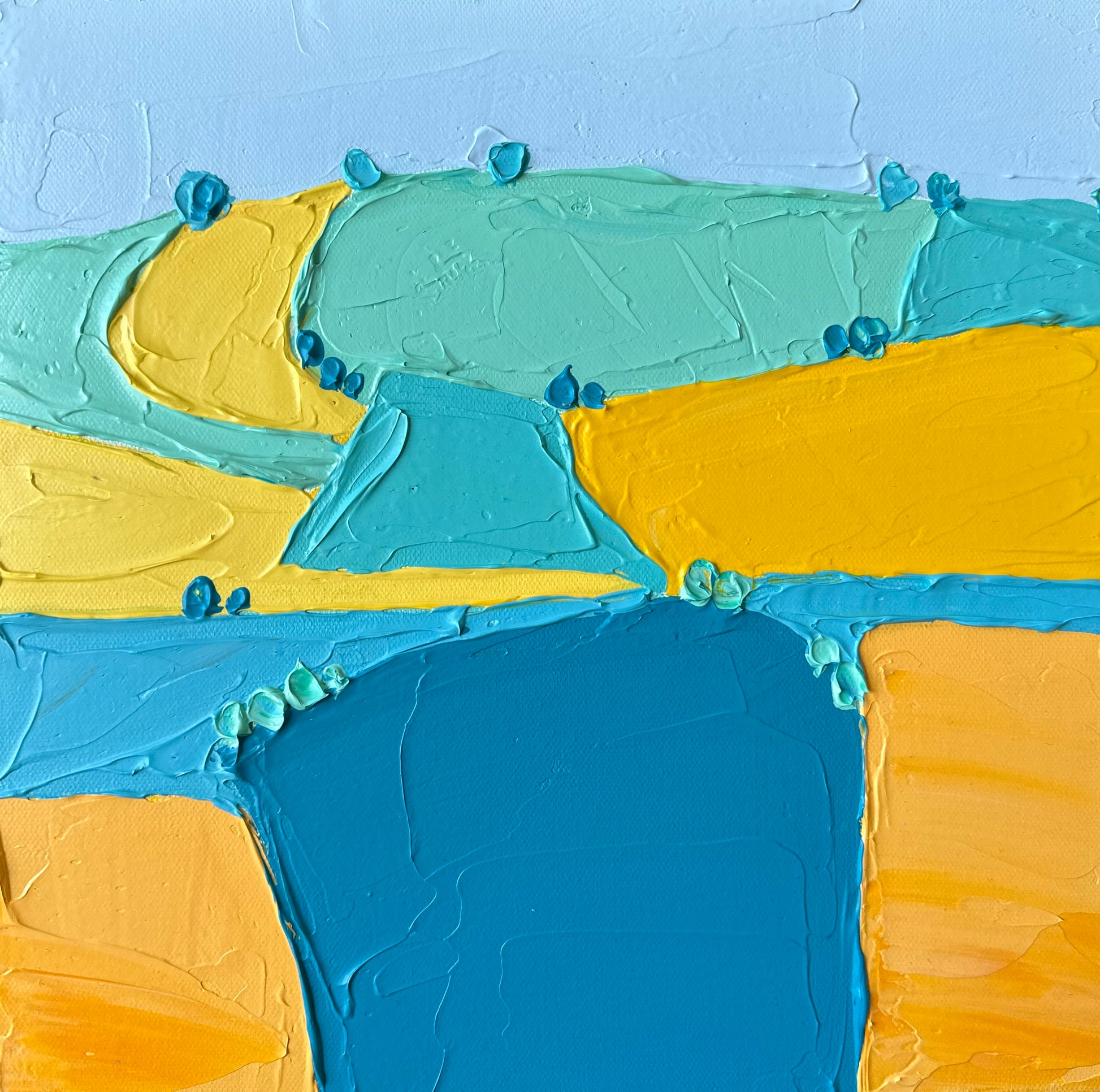 An abstract landscape painting featuring yellow and blue hues with a textured surface.