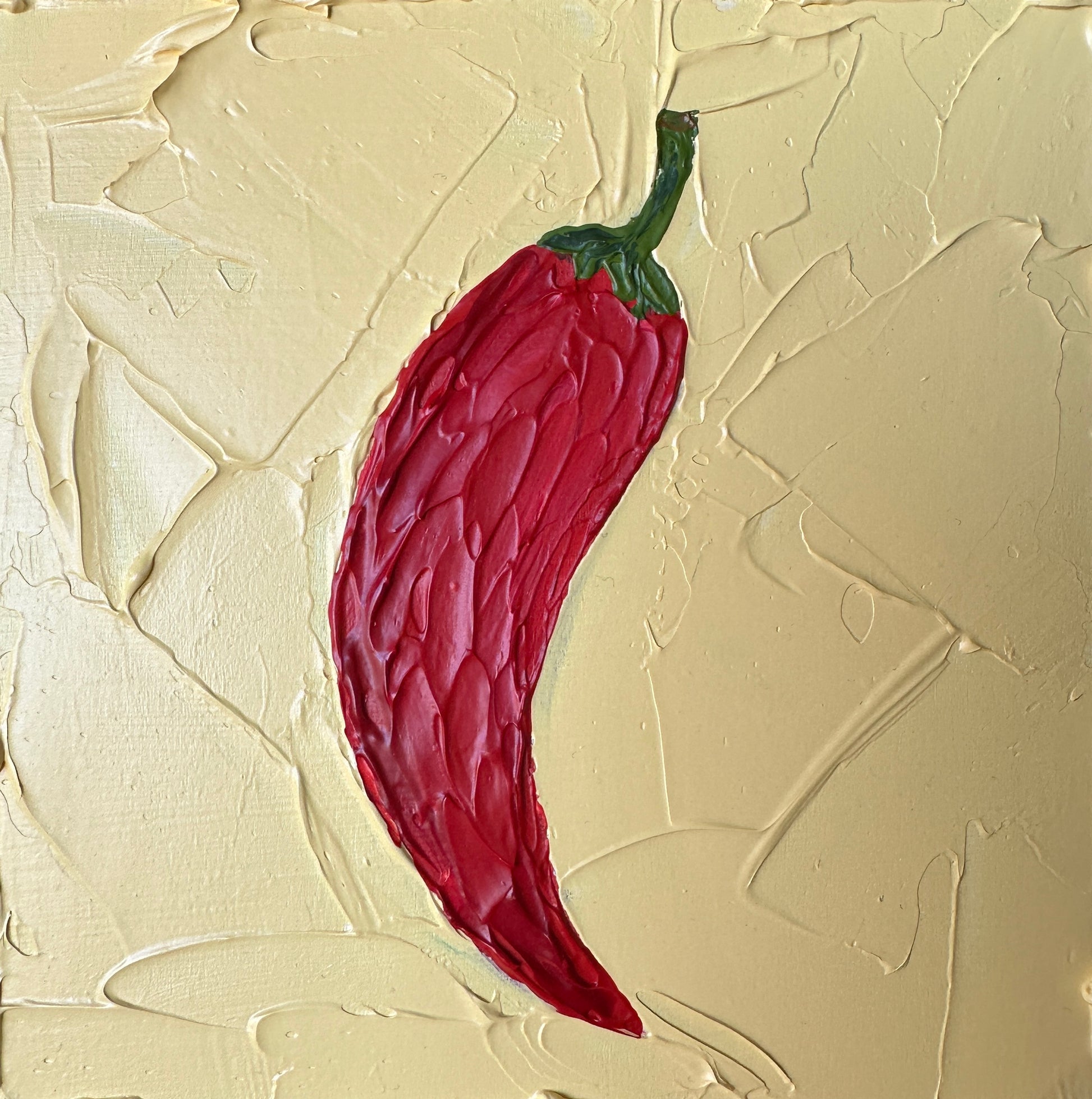 Red chili pepper on a textured beige background