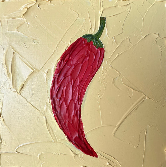 Red chili pepper on a textured beige background