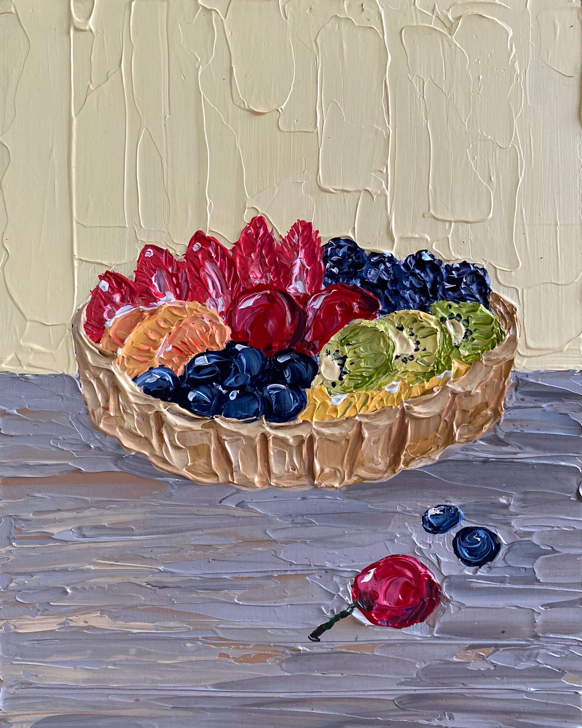 Fruit tart with berries on a textured surface