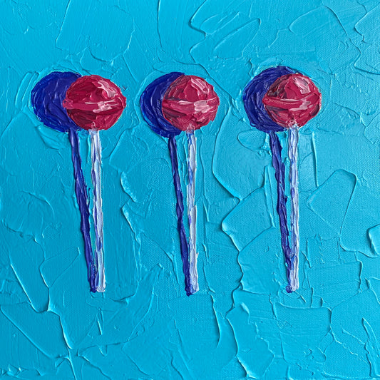 Three red lollipops on blue sticks against a textured blue background