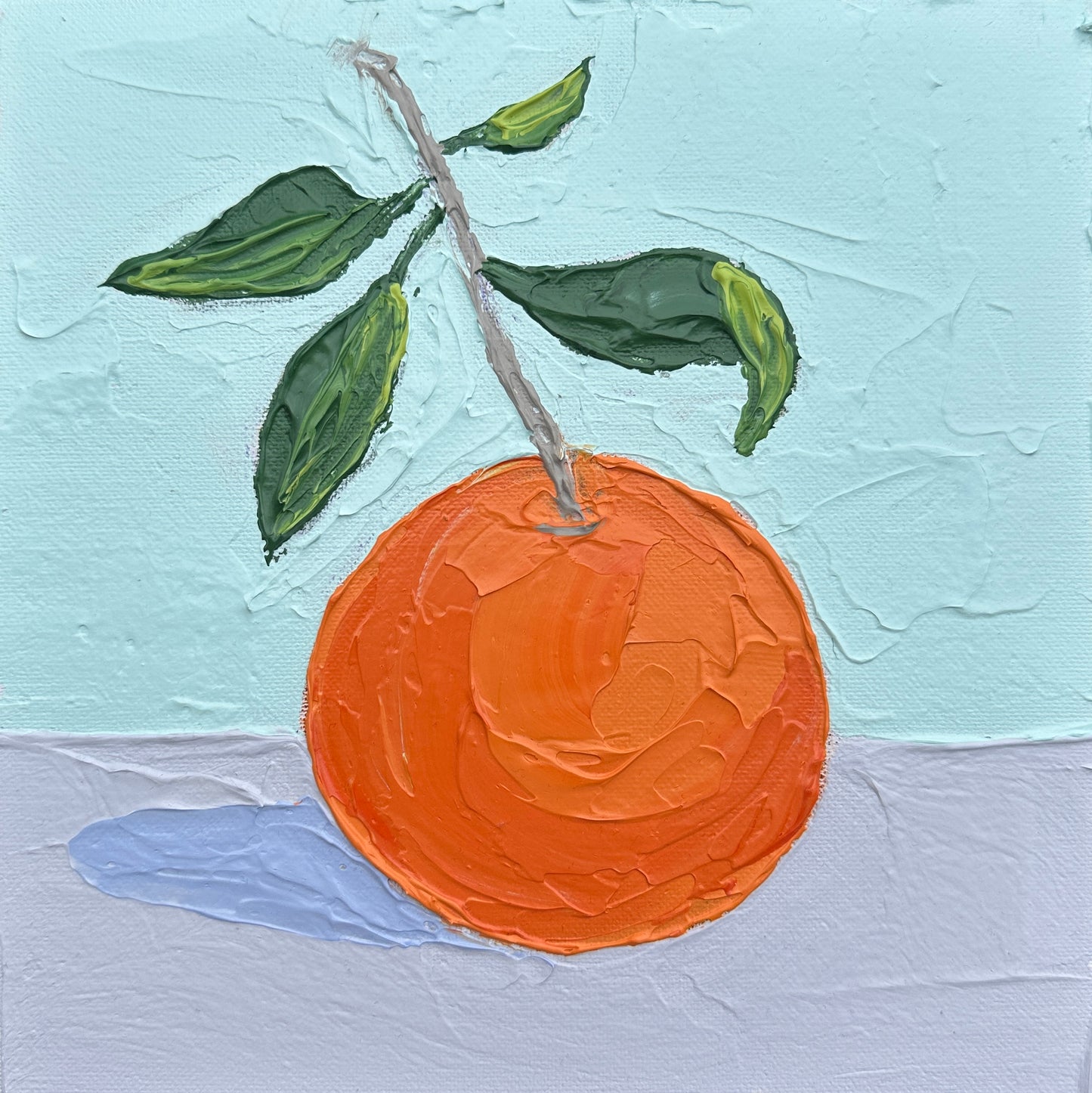 Painting of an orange with green leaves on a textured light blue background