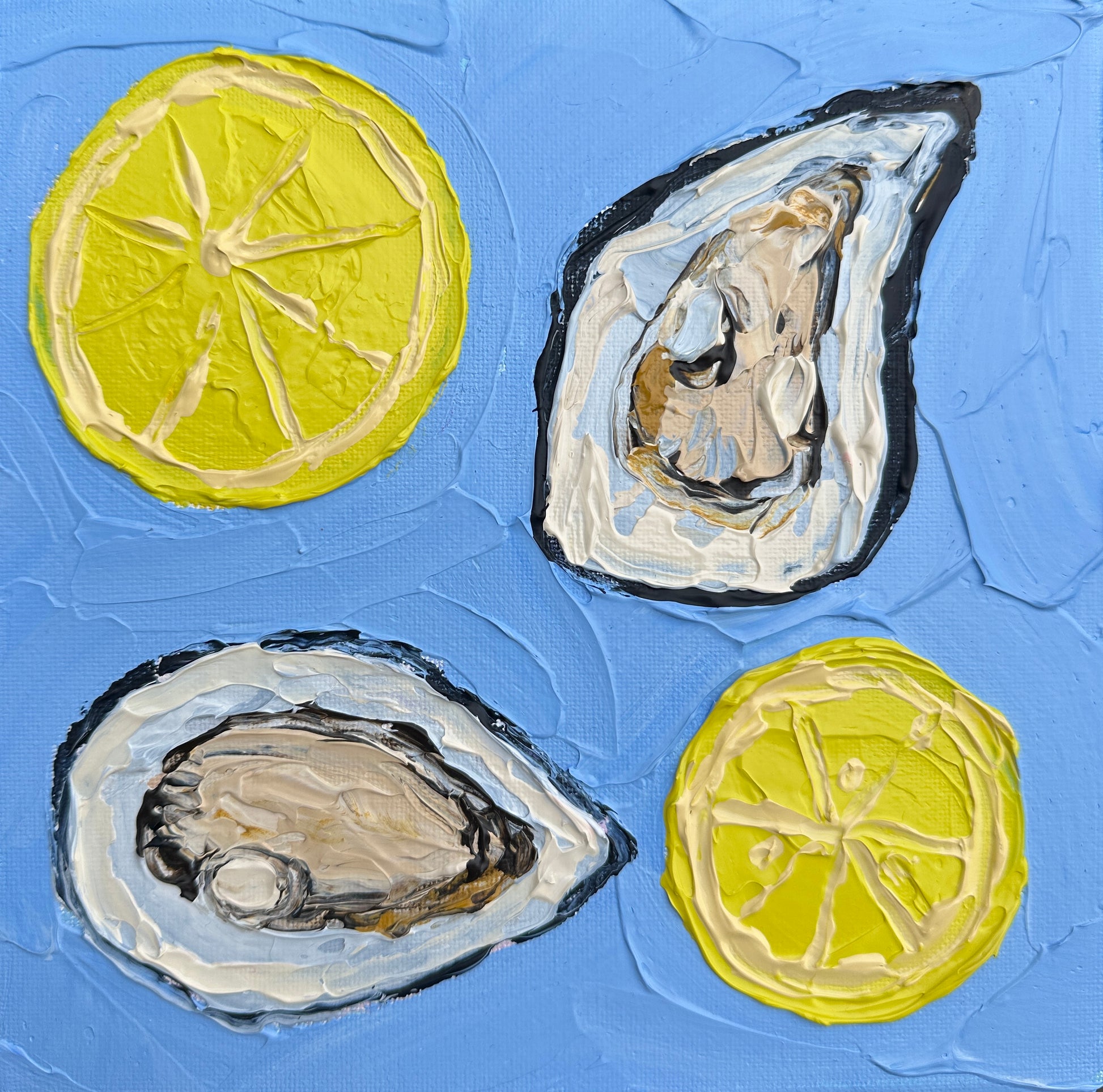 Two oysters and two lemon slices on a textured blue background