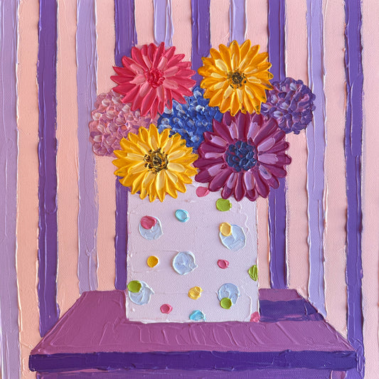 Colorful flowers in a vase on a striped background