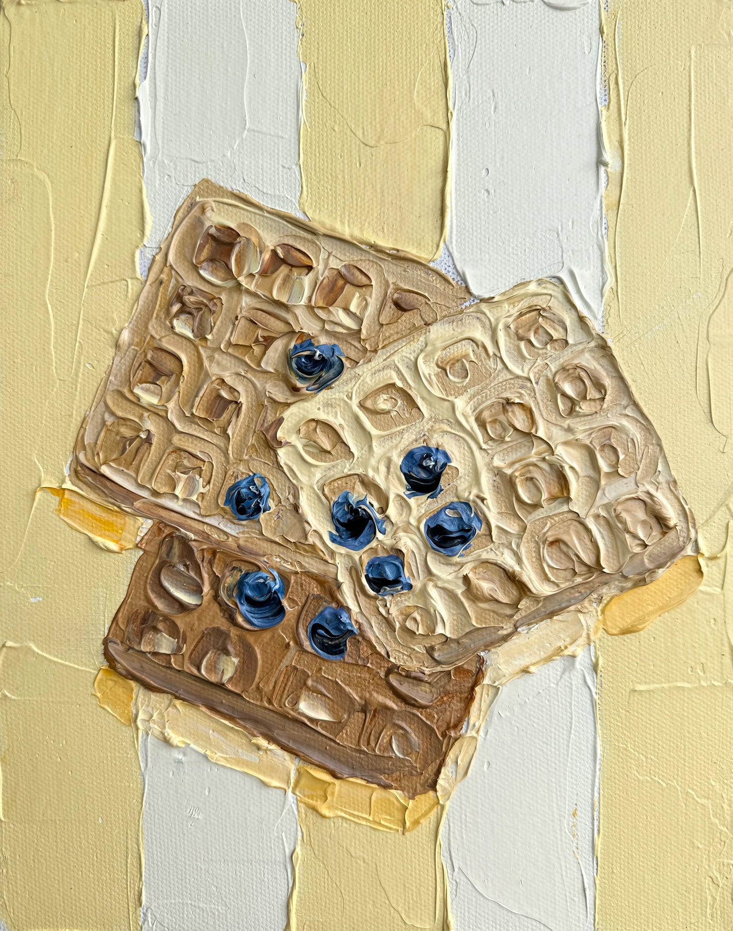 Three cookies with blueberries on a textured beige and white background