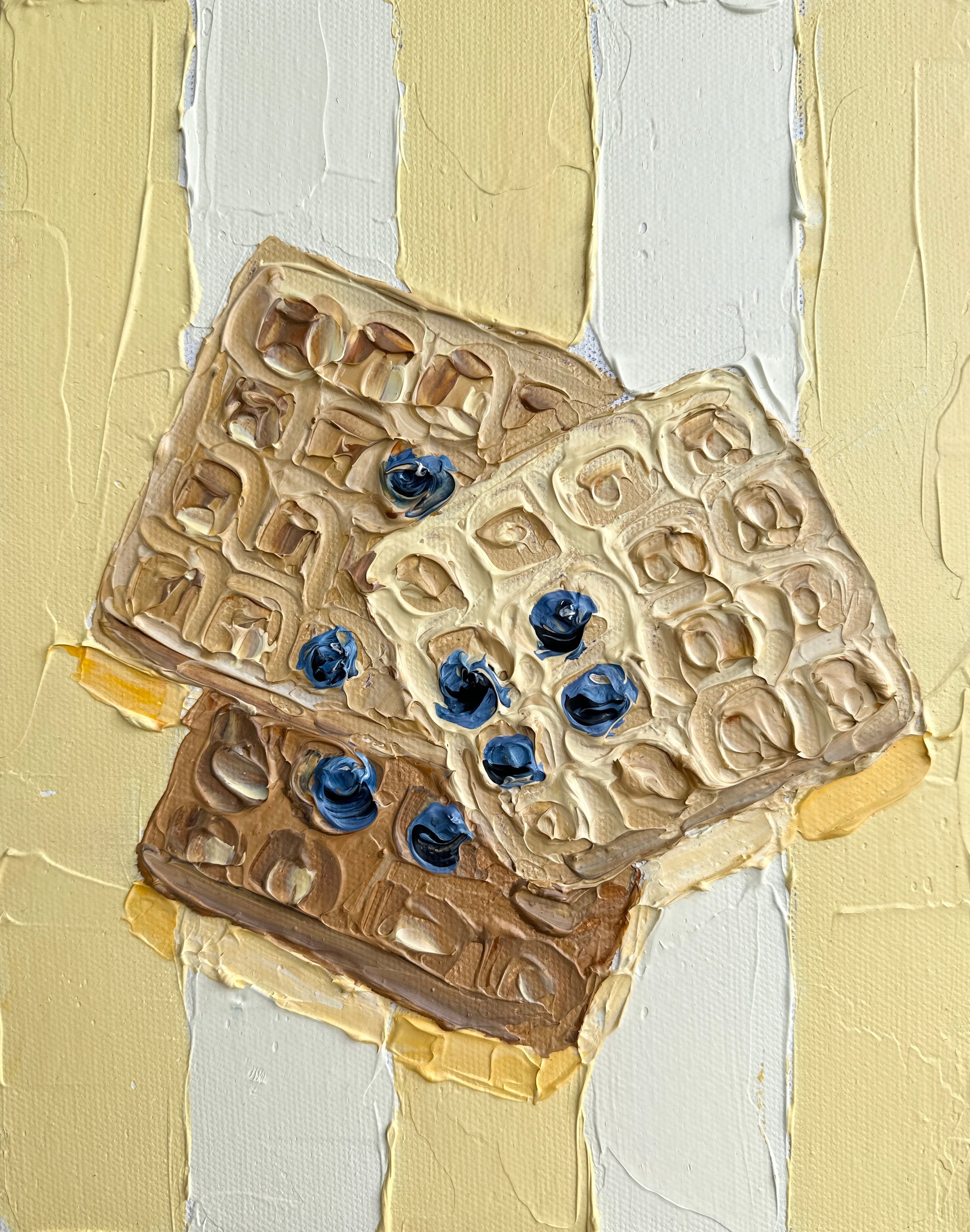 Three cookies with blueberries on a textured beige and white background