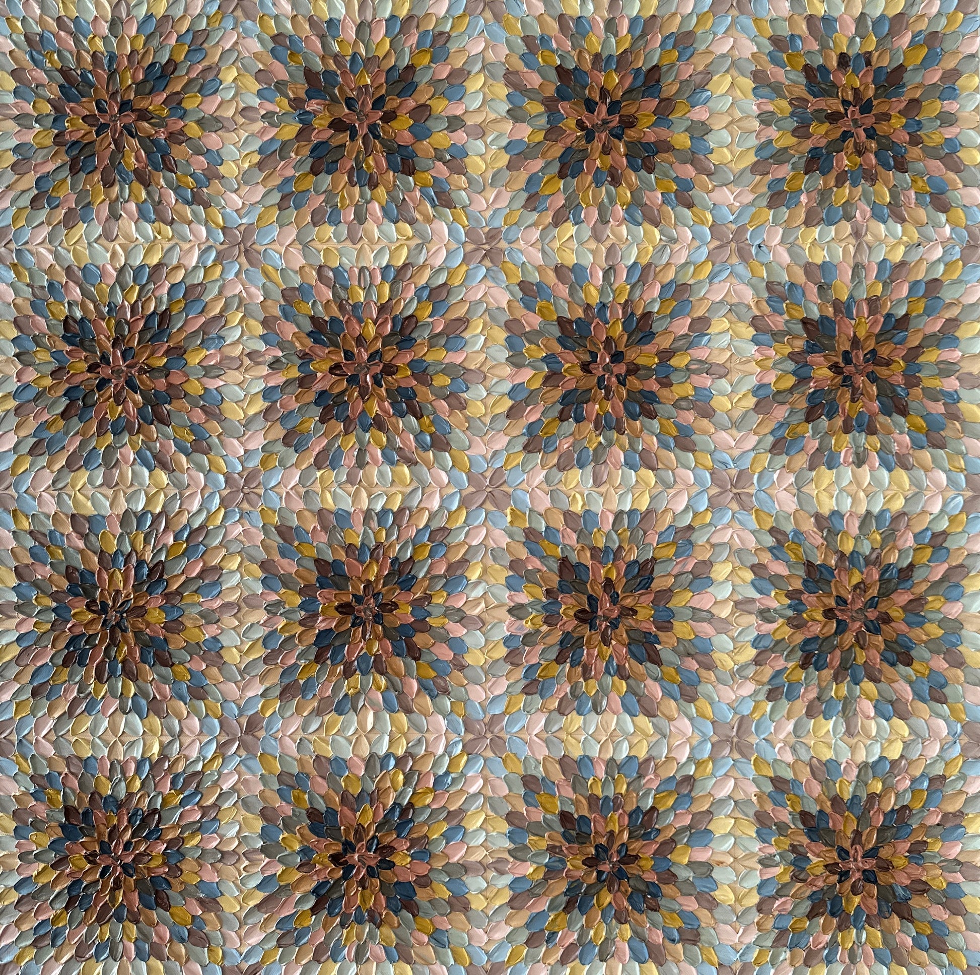 A close-up view of a beige, brown, and blue geometric abstract artwork