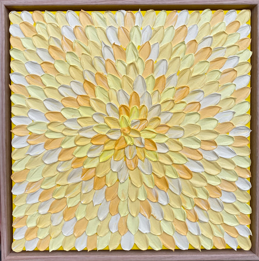 Framed abstract geometric artwork featuring a sunflower pattern in yellow, white, and green hues on a brown frame.